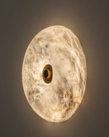 United Alabaster Boutton Wall Light, a round natural alabaster disc with a brass centre button