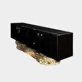 Black high-gloss sideboard with a unique hammered brass base, inspired by the cliffs of Angra do Heroismo. The Angra Sideboard by Boca do Lobo is a true conversation starter.