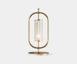 Beaumont: Minimalist Table Lamp in Gold-Plated Brass & Marble. The Beaumont table lamp by Mezzo Collection embodies minimalist luxury. This exquisite piece features a sleek oval frame in gold-plated brass and a Carrara marble base, casting a warm glow in any modern living space.