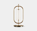 Illuminate Your Living Room with the Beaumont Table Lamp. Add a touch of timeless elegance to your living room with the Beaumont table lamp by Mezzo Collection. This minimalist masterpiece features a gold-plated brass frame and a luxurious Carrara marble base, casting a warm and inviting glow.