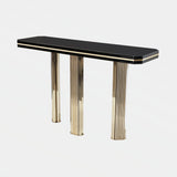 Castro Lighting Harp Console Table in polished brass with a black top, available from Touched Interiors UK