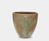 Modern garden design with luxury Atlantis planters in oxidized bronze.