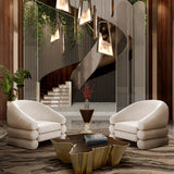 Contemporary luxury accent chair in cream velvet with polished brass accents for sophisticated interiors.