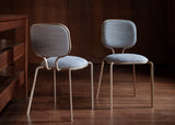 Jacopo Cast Frame Luxury Dining Chair in grey, in a room setting