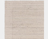 Handcrafted Larson Ivory rug enhancing a contemporary, high-end living room.
