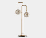 Illuminate Your Living Room with the Miles Modern Floor Lamp. Bathe your living room in a warm, sophisticated glow with the Miles floor lamp by Mezzo Collection. This modern masterpiece features a gleaming gold-plated brass frame and hand-blown glass globes, creating a captivating focal point that embodies the legacy of Miles Davis.