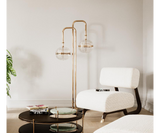 Modern Floor Lamp Design: Gold-Plated Brass & Glass Globes. The Miles floor lamp by Mezzo Collection showcases the perfect balance of modern design and timeless elegance. This image highlights the lamp's key features: a flowing, gold-plated brass frame that gracefully supports delicate, light-diffusing glass globes.