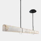 United Alabaster Superloft Pendant Light in natural alabaster with a matt black structure, studio view on grey