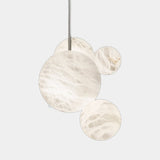United Alabaster Up & Down Pendant Light, natural alabaster spheres, studio view on grey