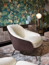 The Art of Modern Seating: The Whitney Armchair. This captivating piece by Visionnaire features an ergonomic design for exceptional comfort, captivating canneté quilted fabric upholstery with contrasting leather accents, and a sleek stainless steel base (available in a variety of finishes). A perfect addition to any luxury living space.
