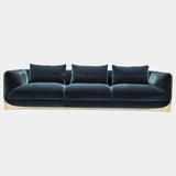 Visionnaire's Ca' Foscari Sofa: Award-Winning Design & Unparalleled Comfort. This modern sofa, designed by Alessandro La Spada (winner of the Archiproducts Design Awards 2022 for Sustainability), features a contrasting interplay of a curved stainless steel base and soft velvet upholstery (other upholstery options available). Memory Foam® comfort and loose feather cushions create a luxurious haven for relaxation.