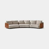 Coleccion Alexandra Giglio Curved Sofa in Shibuya 02 fabric with Milano Clay leather arms and tan finish