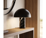 Stylish table lamp with a polished metal finish and marble base, adding a touch of elegance to any high-end living space.