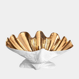 Invest in Timeless Beauty: Neptune Bowl X-Large. This exquisite porcelain bowl, meticulously crafted to resemble a seashell, adds a touch of luxury to any space. (L'Objet Atelier Collection)