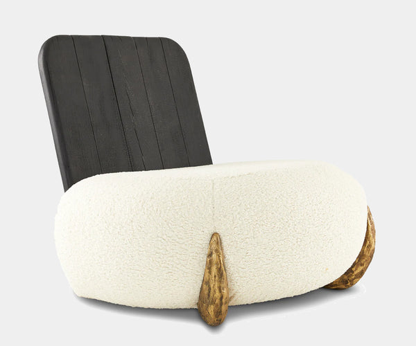 Luxurious cream bouclé lounge chair featuring a Shou Sugi Ban backrest and brass polished buttons for high-end interior design.