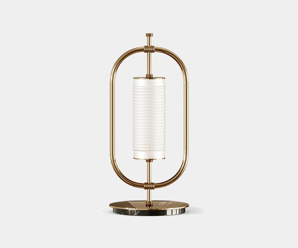 Illuminate Your Living Room with the Beaumont Table Lamp.  Add a touch of timeless elegance to your living room with the Beaumont table lamp by Mezzo Collection. This minimalist masterpiece features a gold-plated brass frame and a luxurious Carrara marble base, casting a warm and inviting glow.