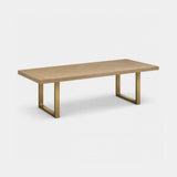 Berkeley Designs Valencia Dining Table, textured natural grey oak veneer with open-frame brass legs, angled view