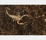 Boca do Lobo Metamorphosis Center Table, close-up of a brass scorpion on Emperador marble