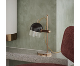 Classic Table Lamp Design: Marble, Brass & Glass.  The Cooper table lamp by Mezzo Collection showcases the enduring power of classic design.  This image highlights the lamp's key materials: luxurious Carrara marble, gleaming gold-plated brass accents, and a sleek glass shade that allows the warm light to shine through.