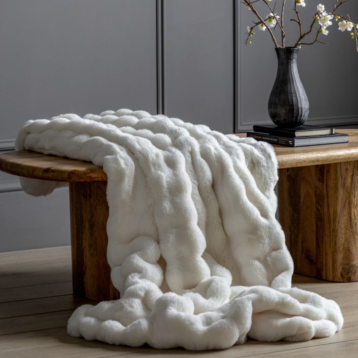 Cloud Cuddle Creamy White Faux Fur Throw. Luxuriously soft, faux fur throw in a calming cream colour. Perfect for adding a touch of cosy comfort to any room.