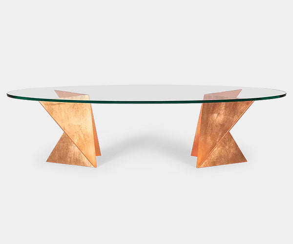 Luxury Origata coffee table by Christopher Guy featuring a sculptural forged iron base and oval glass top.