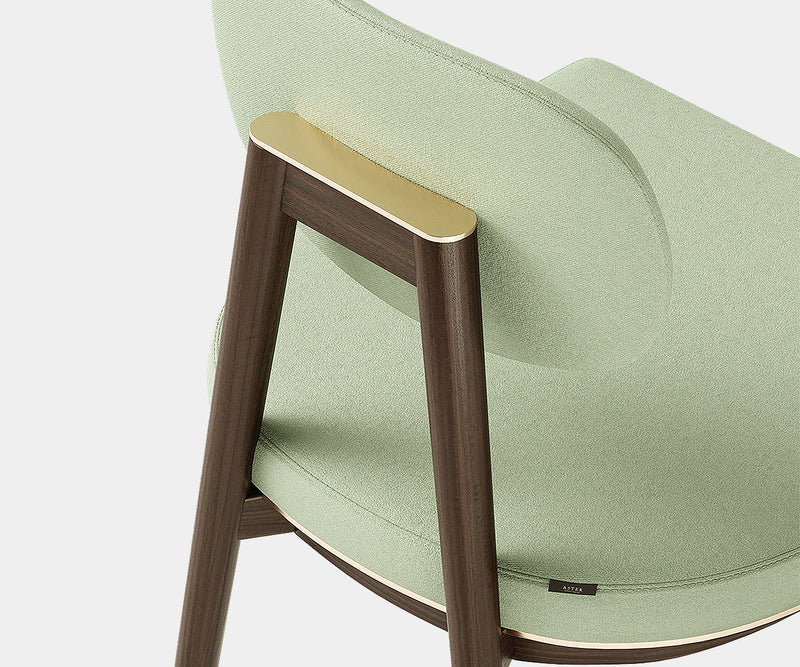 Elegant Oscar dining chair crafted from eucalyptus wood with luxurious fabric upholstery.