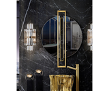 Opulent round mirror with a luxurious brass frame and marble details, ideal for high-end spaces.