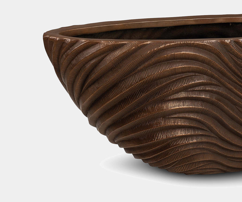 Handcrafted bronze planter vessel for indoor and outdoor use in high-end homes and gardens.