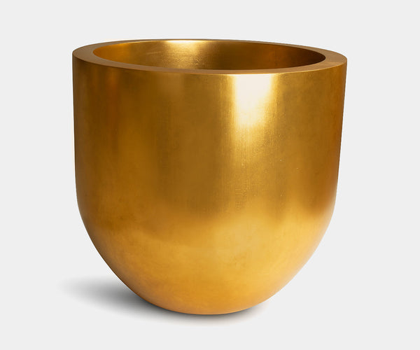 Versatile Pandora planter in gold-leaf finish enhancing a luxury garden design.