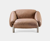 Ghidini 1961 Flo Armchair showcasing luxury mid-century modern design with plush leather cushions.