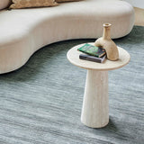 Glam Rug in Aqua beside a curved sofa and stone side table