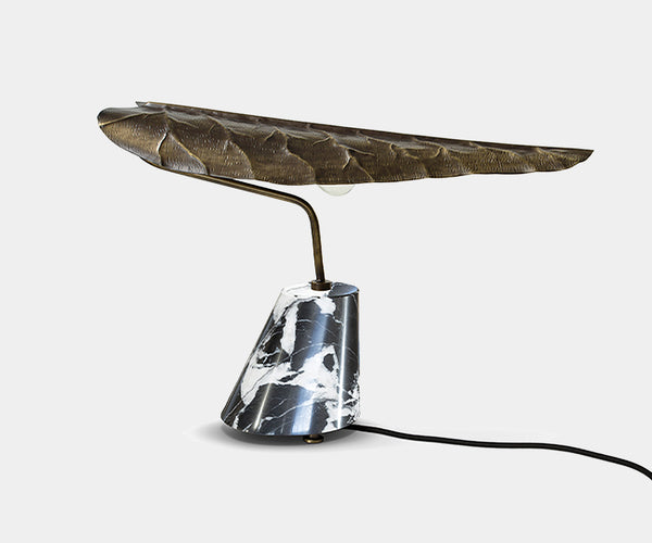 Modern designer table lamp featuring a graceful leaf design in aged brass.