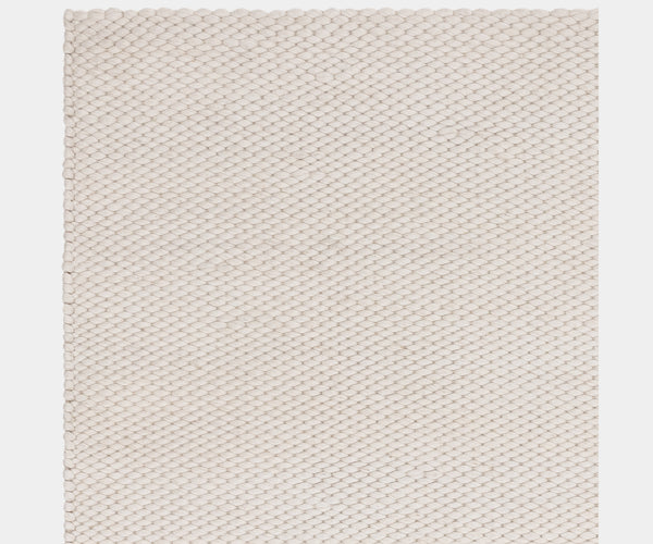 Handcrafted Zander Ivory rug in a wool blend, perfect for luxury interiors.