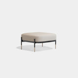 Harlow Floating Frame Luxury Pouf: ivory fabric (Cat B) on a black metal frame with metal tips