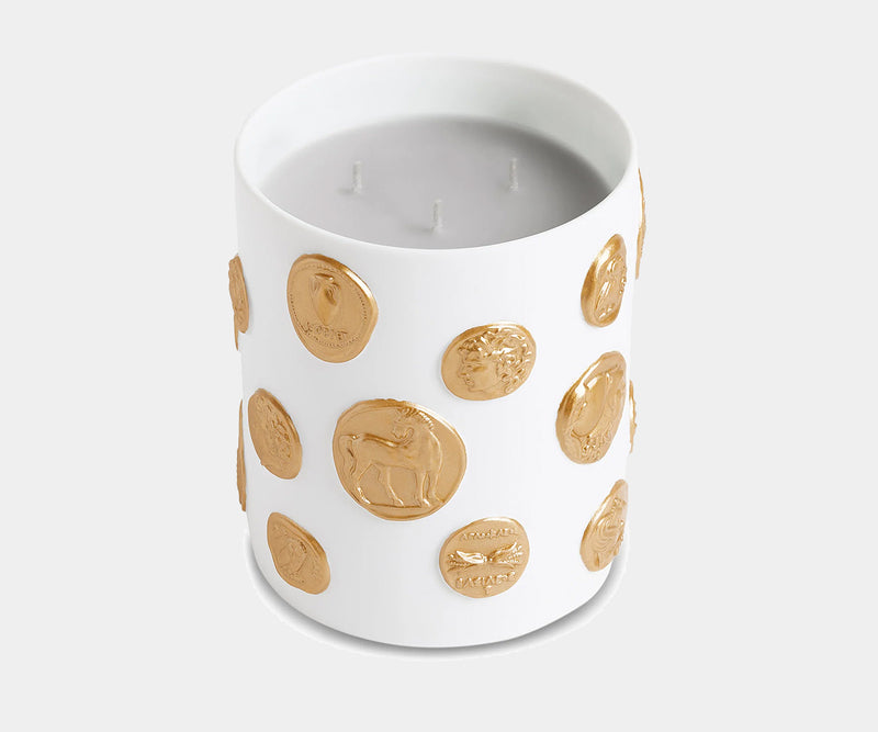 Luxury white porcelain candle by L'Objet, adorned with 24k gold coins for an elegant interior design accessory.