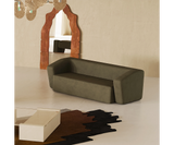 Modern suede sofa designed for comfort, perfect for relaxing or entertaining guests.