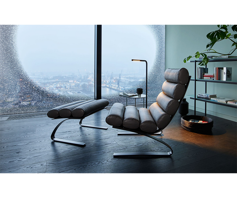 Luxury interior design with the timeless Sinus Armchair, a modern classic furniture piece.