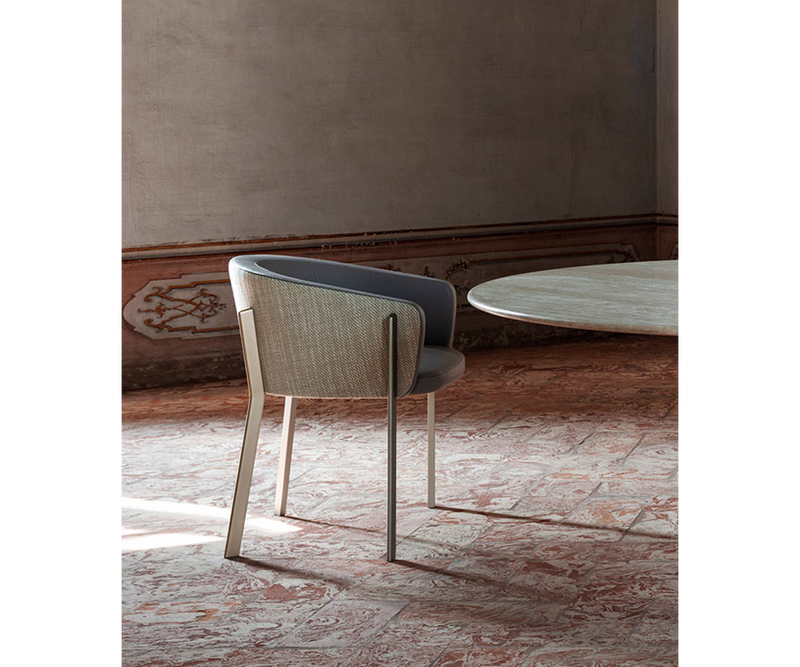 Timeless Ghidini 1961 Arch Chair as a statement piece in luxury living spaces.