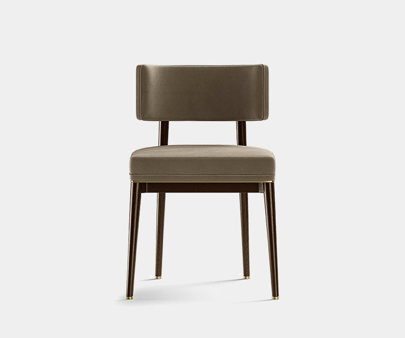 Luxury modern dining chair featuring elegant upholstery and refined brass details.