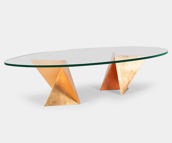 Modern luxury coffee table inspired by Japanese origami, with a striking iron base and transparent glass top.