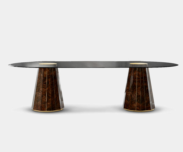 Luxxu Darian Oval Dining Table featuring walnut root, polished brass, and smoked glass