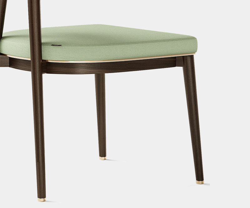 Sophisticated modern dining chair with brass accents and a refined eucalyptus wood frame.