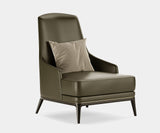 Aster Collection Redd luxury armchair with curvy design and black stained oak wood, featuring elegant brass accents.