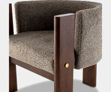 Sophisticated grey bouclé dining chair with solid walnut frame, designed for timeless elegance in luxury dining spaces.