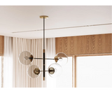 Statement piece chandelier with a contemporary design and refined metallic details for modern homes.