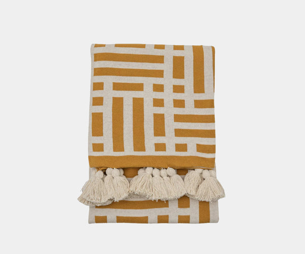 Embrace the Trending Ochre Look: Knit Throw with Cozy Cream Accents & Tassels. This on-trend ochre knit throw with cosy cream accents and tassels is the perfect addition to your modern living space.