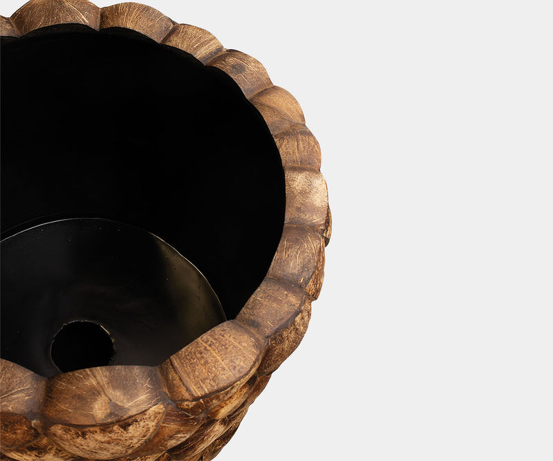 High-end real estate decor featuring a coconut shell floor vase.