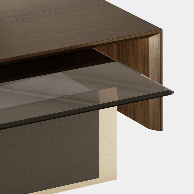 Inspired by modern architecture, the Robert Center Table is a combination of fluid clean lines and materials. The brass on the foot is involved by a thin wood layer, offering support to a rectangular surface made out of glass. Embellishing the design, it arises a beautiful wood structure protecting the vulnerability of the interior structure.