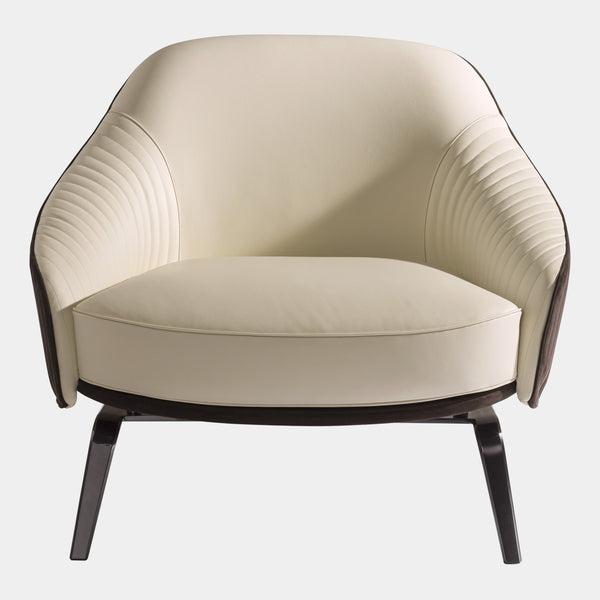 Visionnaire's Whitney Armchair: Ergonomic Comfort Meets Artistic Design. This modern armchair boasts a curved frame for exceptional support, luxurious canneté quilted fabric upholstery with contrasting leather accents, and a customisable stainless steel base. Perfect for any discerning luxury interior design enthusiast.